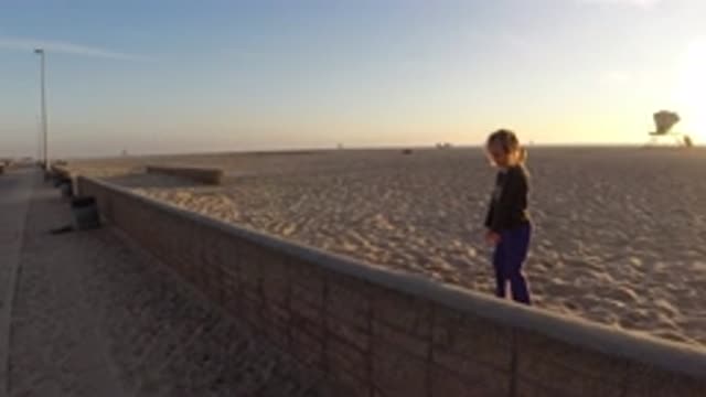 BOLSA CHICA CALIFORNIA-2019: A Toddler Walking on Sand in a Large Sandy Land Mass