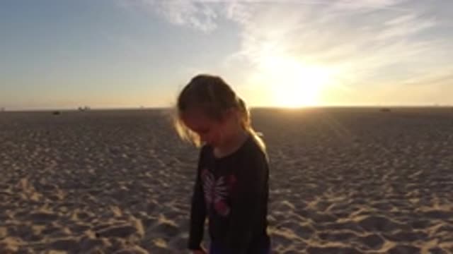 BOLSA CHICA CALIFORNIA-2019: Kid Walking Around On The Beach In The Sand By