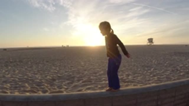 BOLSA CHICA CALIFORNIA-2019: Little Cute Toddler Walking On The Edge Of A Wall