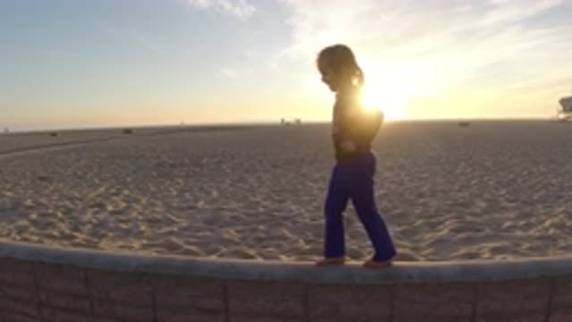 BOLSA CHICA CALIFORNIA-2019: Girl Playing To Balance On The Mural In The Late