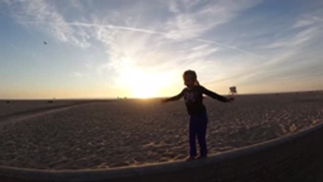 BOLSA CHICA CALIFORNIA-2019: A Kid Practicing Balance In Slow Motion In The