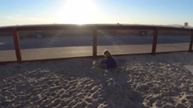 BOLSA CHICA CALIFORNIA-2019: Child Loves To Play With Sand Sitting On The Beach
