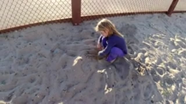 BOLSA CHICA CALIFORNIA-2019: Young Girl Playing in the Sand Alone