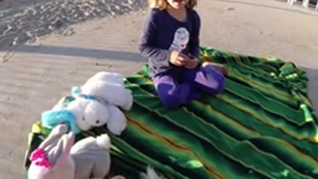 BOLSA CHICA CALIFORNIA-2019: Playtime On Green Striped Blanket With Child