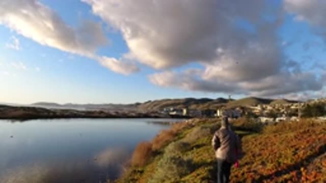 PISMO BEACH CALIFORNIA-2019: Girl Takes A Relaxing Stroll Alongside River