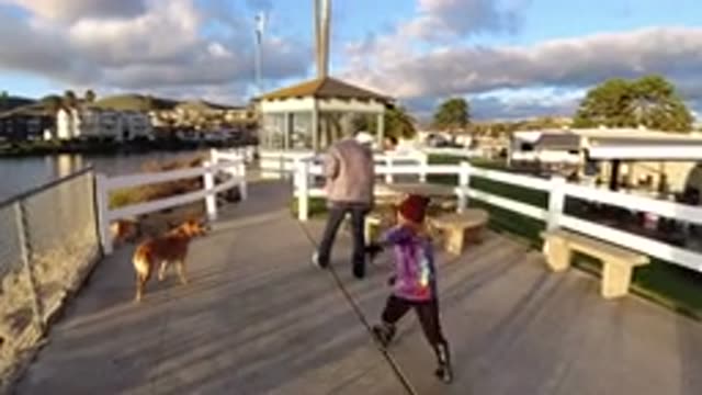 PISMO BEACH CALIFORNIA-2019: Mother And Son Walk Along Boardwalk With Dog Beside