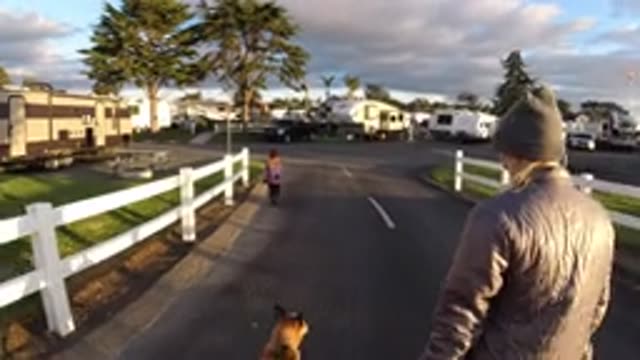 PISMO BEACH CALIFORNIA-2019: Blond Person Walks Dog While Child Runs Ahead