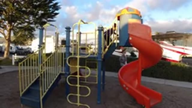 PISMO BEACH CALIFORNIA-2019: A Child Entering A Slide At The Playground As The