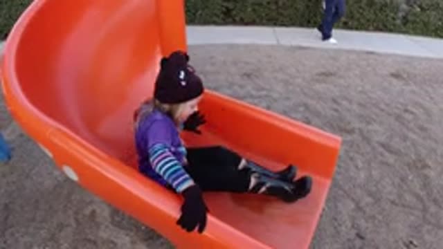 PISMO BEACH CALIFORNIA-2019: A Person Sliding Down An Orange Slide