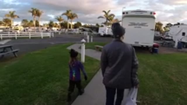 PISMO BEACH CALIFORNIA-2019: Blonde Woman Walking With Child On Sidewalk