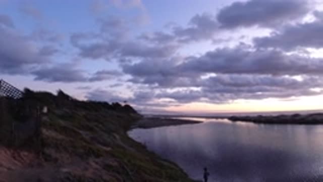 PISMO BEACH CALIFORNIA-2019: A Person Walking Near A Still Body Of Water While