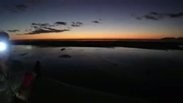 PISMO BEACH CALIFORNIA-2019: Silhouette of Person Standing by River at Sunset