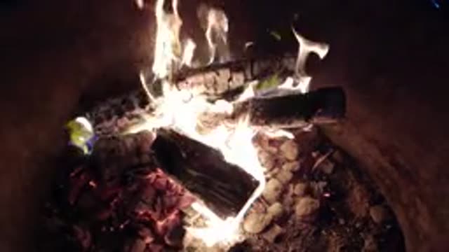 PISMO BEACH CALIFORNIA-2019: Wood Fire Slowly Burning Inside A Metal Barrel In