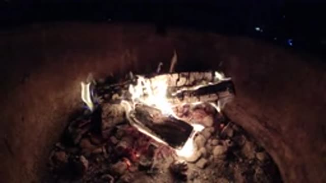 PISMO BEACH CALIFORNIA-2019: Beautiful Campfire On Logs At Night With Rocks And Sand