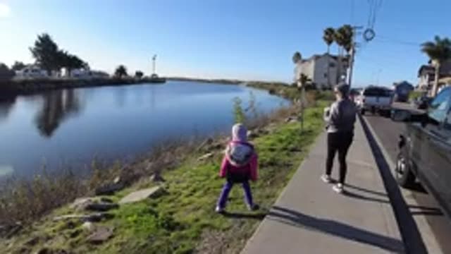 PISMO BEACH CALIFORNIA-2019: Family Walking Near A Beautiful Cold Lake With A Dog
