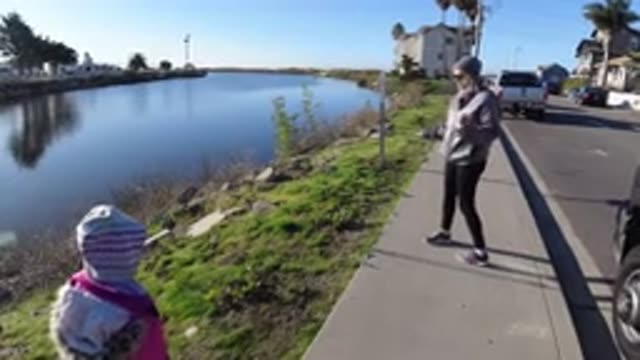 PISMO BEACH CALIFORNIA-2019: Mother And Daughter Strolling On Sidewalk With Dog