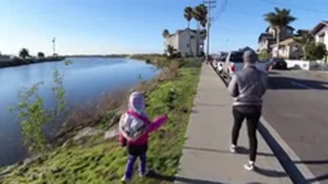 PISMO BEACH CALIFORNIA-2019: An Older Woman With A Tiny Child Next To Her