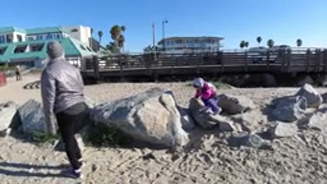 PISMO BEACH CALIFORNIA-2019: Climbing On Rocks At The Beach