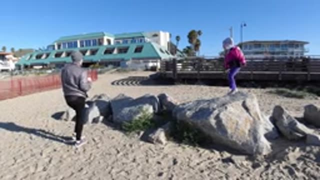 PISMO BEACH CALIFORNIA-2019: Mom And Daughter Playing On The Shore