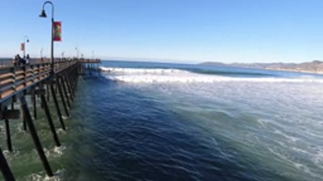 PISMO BEACH CALIFORNIA-2019: View From Pier Of Waves Rolling In Toward Shore