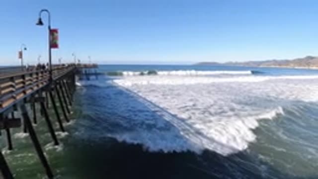 PISMO BEACH CALIFORNIA-2019: Wooden Pier Over Water With Waves Rolling