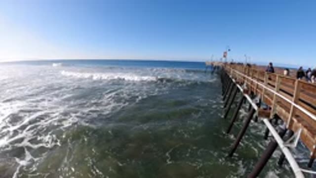 PISMO BEACH CALIFORNIA-2019: People On The Shore Watching Another Big Wave Pass
