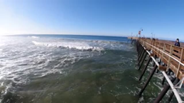 PISMO BEACH CALIFORNIA-2019: Early Morning Joggers Enjoy The Ocean On A Pier