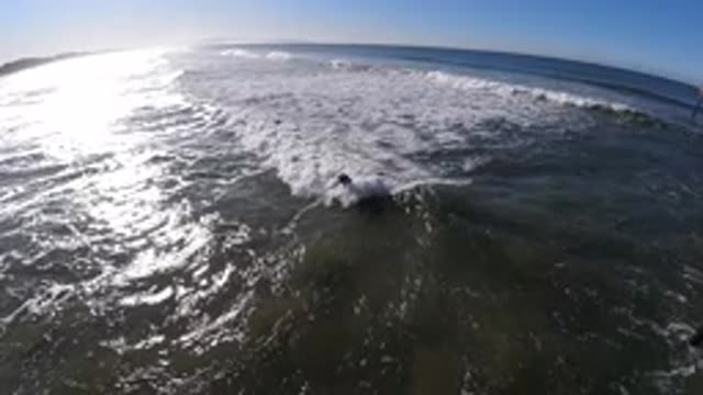 PISMO BEACH CALIFORNIA-2019: Panoramic Surfer Standing On Board Catching Wave