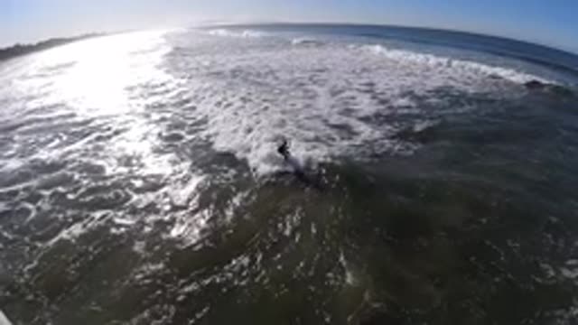 PISMO BEACH CALIFORNIA-2019: A Surfer Is Standing On The Waves Of The Sea Near