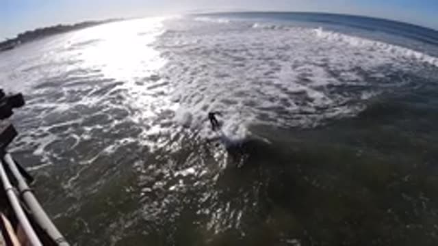 PISMO BEACH CALIFORNIA-2019: A Man Water Skis Across the Waves