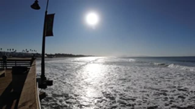 PISMO BEACH CALIFORNIA-2019: Waves Crashing On The Sandy Beach Under The Warm