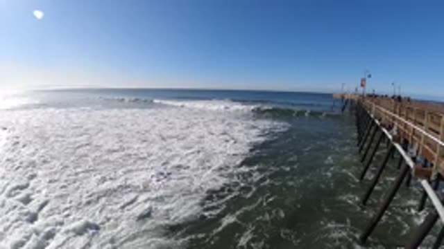 PISMO BEACH CALIFORNIA-2019: Brown Wooden Pier Over Half Frozen Lake On A Sunny