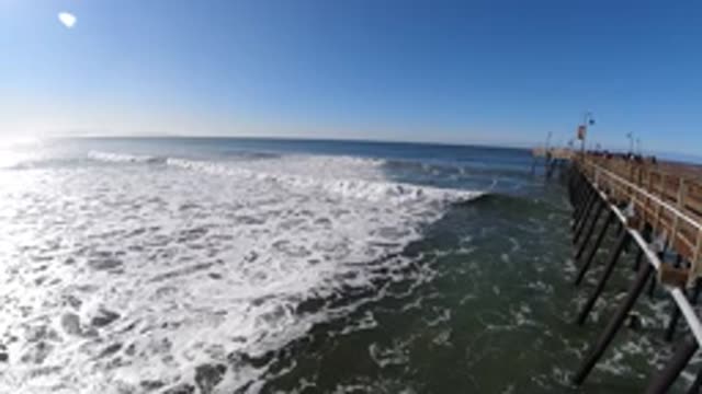 PISMO BEACH CALIFORNIA-2019: Brown Pier Over Half Frozen Lake On A Sunny Day
