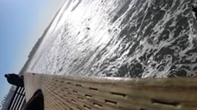 PISMO BEACH CALIFORNIA-2019: People Filming And Watching Surfers Paddling Their Boards