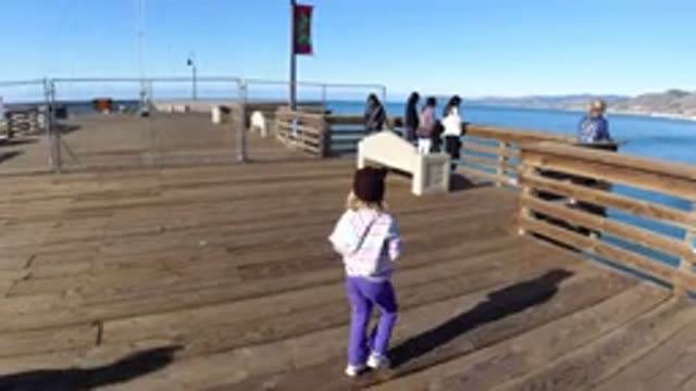 PISMO BEACH CALIFORNIA-2019: Chic Child Walking In Picturesque Boardwalk On A