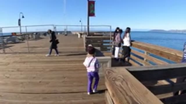 PISMO BEACH CALIFORNIA-2019: Family On A Walk On The Oceanfront Platform In