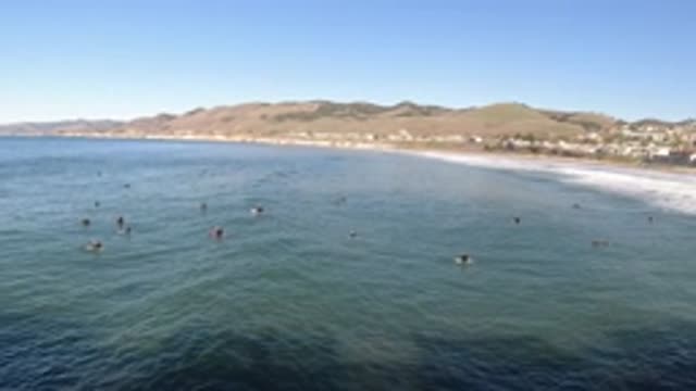 PISMO BEACH CALIFORNIA-2019: People In An Ocean Filled Basin Near The Shore On A