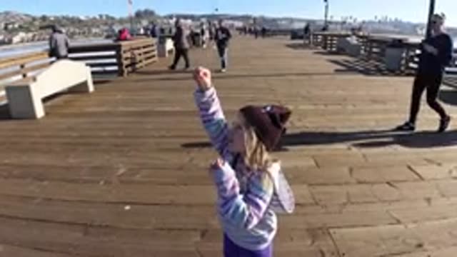 PISMO BEACH CALIFORNIA-2019: Child Eating Gum Pulls and Having Fun