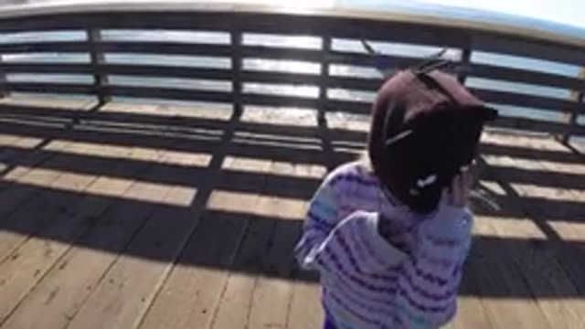PISMO BEACH CALIFORNIA-2019: Girl Walking Outdoors On A Pier By The Ocean While