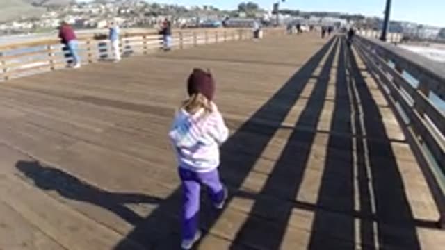 PISMO BEACH CALIFORNIA-2019: A Little Blond Girl Turning Around and Whipping Her Hair
