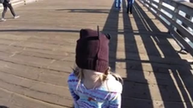 PISMO BEACH CALIFORNIA-2019: Child On Boardwalk With Brown Hat Covering Their Face