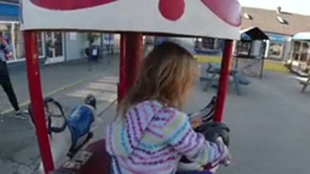 PISMO BEACH CALIFORNIA CALIFORNIA USA-2019: Young Girl Riding A Carousel At An Amusement Park