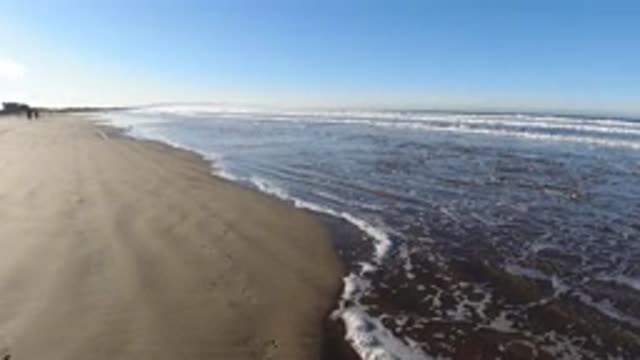 PISMO BEACH CALIFORNIA-2019: People Running On Beach In The Distance At Low Tide