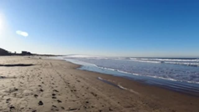 PISMO BEACH CALIFORNIA-2019: Tiny Waves Crashing On Beautiful Sandy Beach On