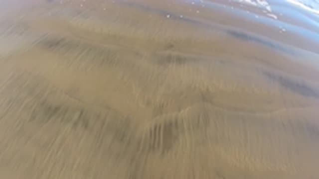 PISMO BEACH CALIFORNIA-2019: A Person Walks On Sand At The Beach