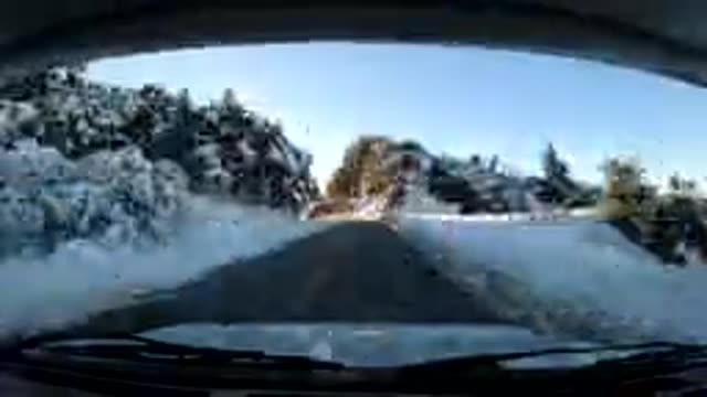 CENTRAL COAST CALIFORNIA-2019: Vehicle Moves Along Winding Mountain Road Snow On