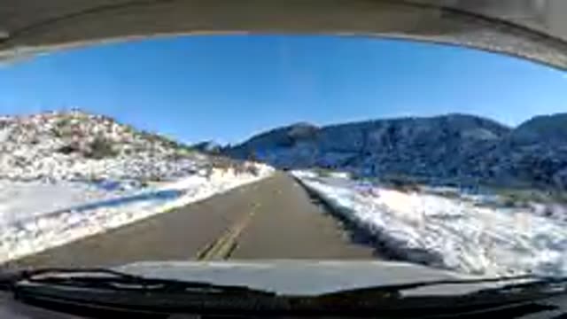 CENTRAL COAST CALIFORNIA-2019: High Speed Car Running Down A Snowy Road