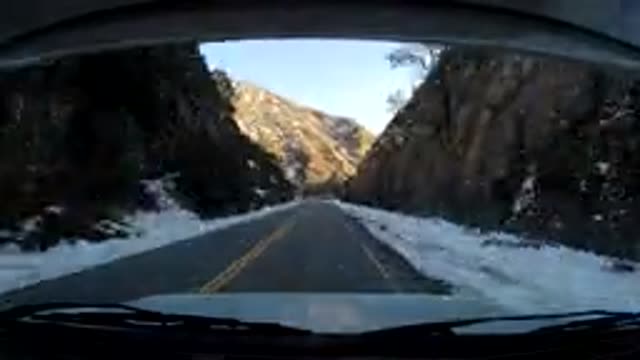 CENTRAL COAST CALIFORNIA-2019: Vehicle Moves Along Winding Snowy Road Film Seeded