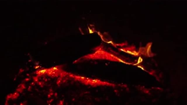 OJAI CALIFORNIA-2019: Fire Producing Red Flames In Woods On A Campfire At Night