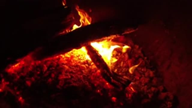OJAI CALIFORNIA-2019: The Fire Envelops the Wood Burning in the Dark